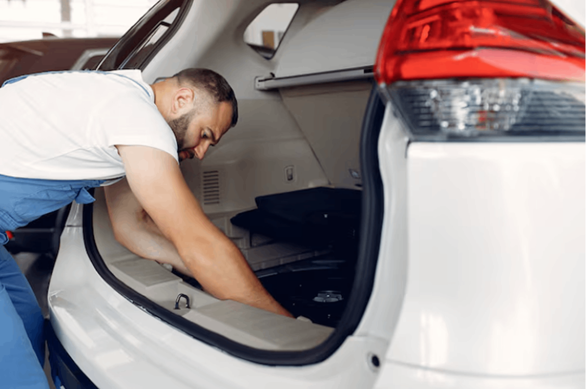 A mechanic repairing the car.