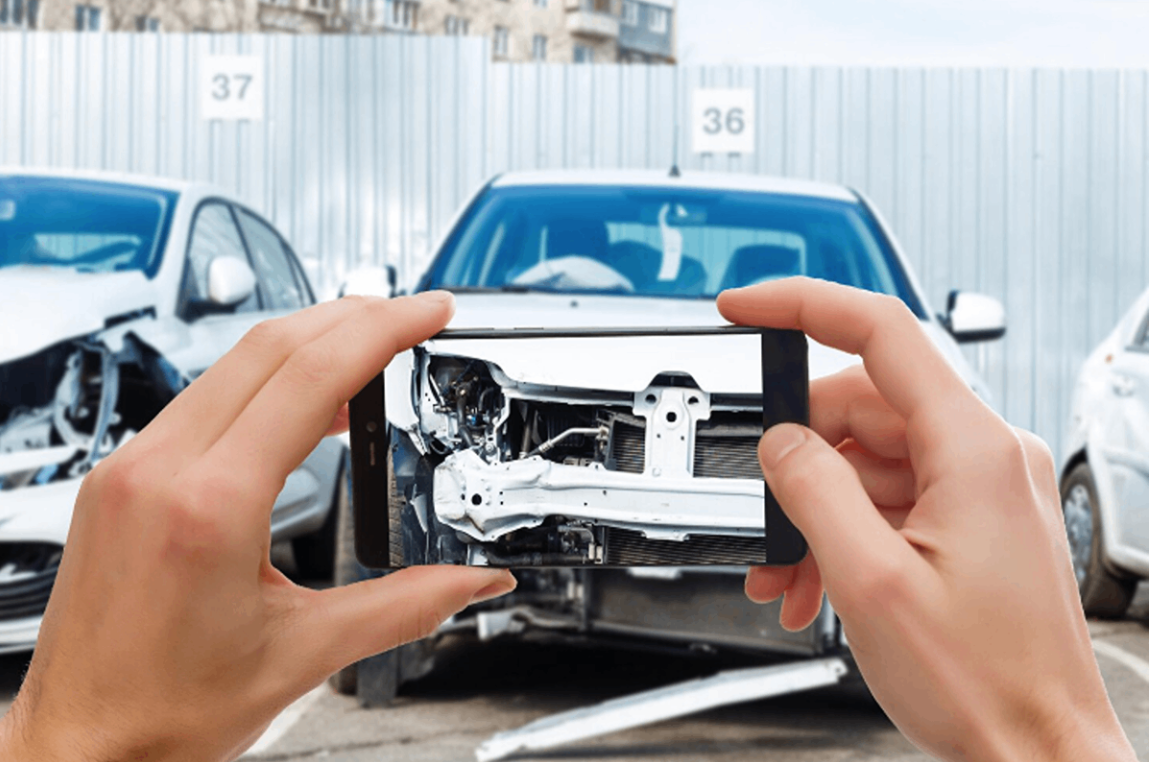 Taking a picture of a damaged car.